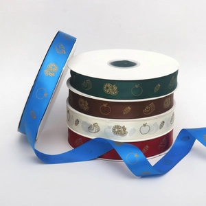 Close-up of decorative polyester ribbons with gold-foiled fruit icons for gift wrapping