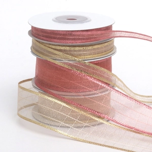 Detail of pink and champagne organza ribbons with metallic edges on white spools