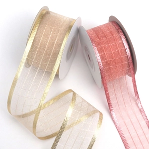 Sheer sparkling organza ribbons in champagne and pink colors for gift wrapping and DIY crafts