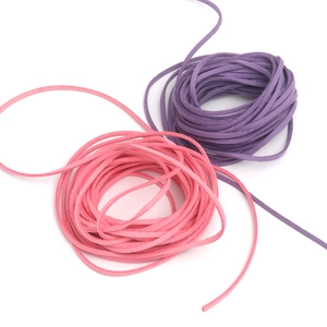 Detailed close-up of 2.6mm pink and purple suede cords for DIY jewelry making