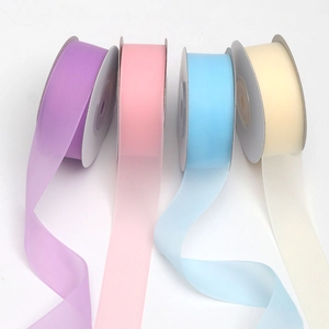 Detail of four translucent jelly yarn ribbon rolls in pastel shades for gift wrapping
