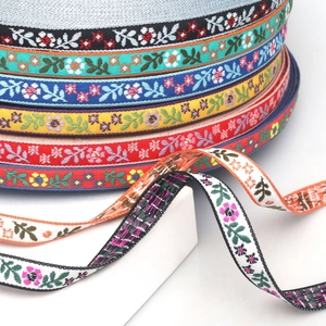 Close-up of colorful bohemian floral jacquard ribbon trims stacked on white display