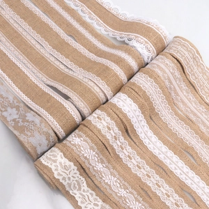 Detail of natural jute burlap ribbon rolls with white floral embroidery lace for DIY crafts