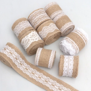 Macro detail of natural jute ribbon rolls with delicate white lace edges for DIY crafts