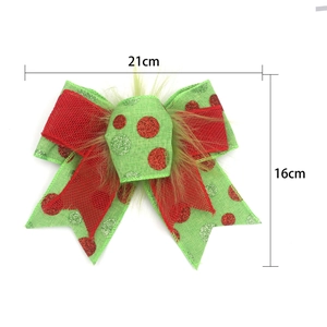 Detail view of green Christmas bow with red dots and plush center, 21cm x 16cm size