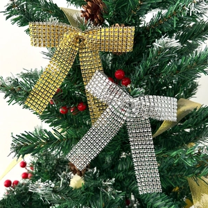 Detail of gold and silver Christmas bow ornaments with rhinestones on a festive tree