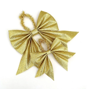 Golden Christmas bows with glitter and silver star sequins for holiday gift box decoration
