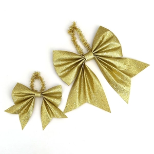 Set of two golden glitter bows with hanging loops for Christmas tree and gift decoration