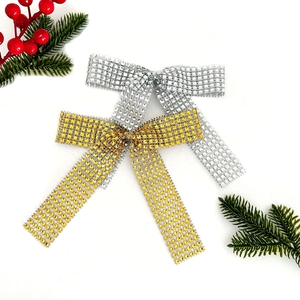 Close-up of gold and silver hollow bow decorations with rhinestones for Christmas decor