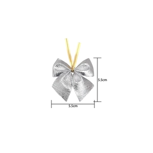Close-up of 5.5cm silver metallic bow decoration with foil texture for DIY gift wrapping