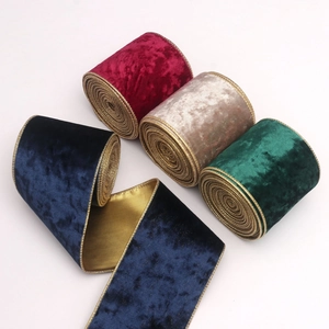 Detail of 10cm velvet Christmas ribbons with gold wire edges in blue, red, gold and green