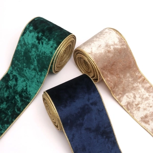 Detail of 10cm velvet Christmas ribbons with gold wired edges in emerald blue and gold