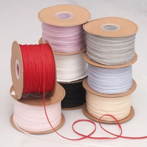Close-up of assorted colorful ruffles edge polyester ribbons on kraft paper spools