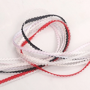 Detailed view of 3mm ruffled edge polyester ribbons in red black and white colors
