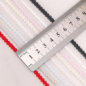Macro view of 0.3cm wavy ruffled polyester ribbons in various colors with a measuring scale