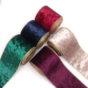 Five rolls of velvet Christmas ribbons with gold wired edges in assorted festive colors