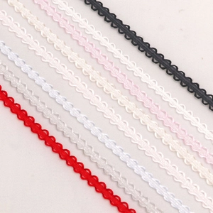 Close-up of 3mm scalloped edge polyester ribbons in assorted vibrant colors for DIY crafts
