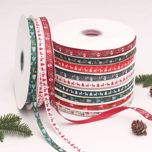 Detail of 1cm ribbed Christmas ribbons with reindeer and trees for DIY gift wrapping