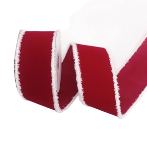 Red velvet Christmas ribbon with white faux fur edges on a spool for DIY gift decor