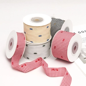 Colorful houndstooth ribbons with flocked dots on spools for DIY sewing and gift wrapping