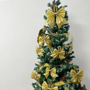 Close-up of sparkling gold glitter bows and translucent ribbons on a Christmas tree