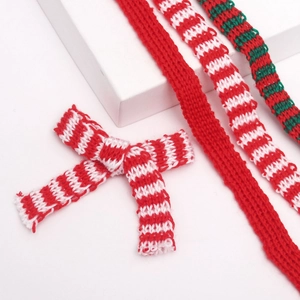 Detail of Christmas knitted ribbons and bows in red, white and green festive patterns