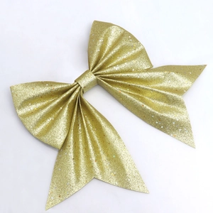 Detail of golden glitter bow with colorful star sequins for Christmas tree decoration