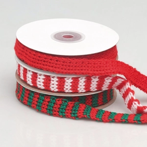 Three rolls of Christmas knitted ribbons in red, red-white, and red-green holiday styles