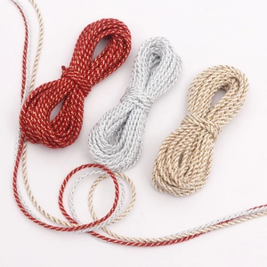 Macro view of 3mm metallic braided ropes in red-gold, silver, and gold-white for DIY crafts