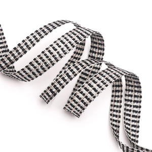Detail of black and white checkered ribbon with metallic silver edges for gift wrapping