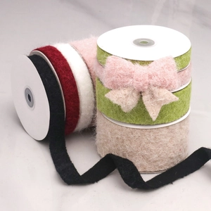 Close-up of colorful velvet ribbons on spools for DIY bows and gift wrapping
