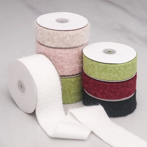 Macro shot of colorful flocked velvet ribbons with soft plush texture for DIY crafts