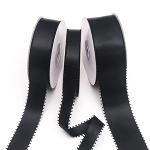 Detail of black picot edge satin ribbon rolls for gift wrapping and DIY bows