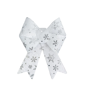 Close-up of white Christmas bow with silver snowflake print and subtle glitter texture