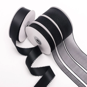 Detail of black satin and organza ribbons with delicate picot edges for DIY gift wrapping
