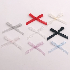 Detailed close-up of 8 assorted pastel lace bow embellishments for DIY craft and sewing
