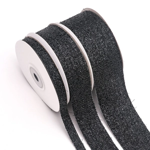 Close-up of black metallic glitter ribbons in three widths for DIY gift wrapping