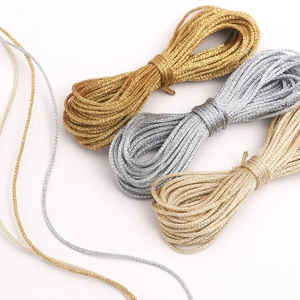 Close-up of 1mm metallic braided ropes in gold and silver for DIY Christmas gift packaging