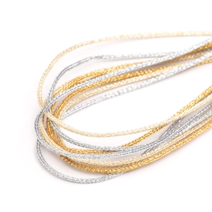 Macro detail of 1mm metallic gold and silver braided twine for DIY Christmas gift wrapping