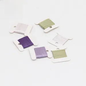 Detail of 3mm double-sided polyester satin ribbons on H-shaped white plastic spools