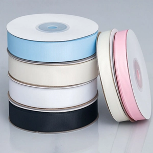 Close-up of assorted colorful grosgrain ribbon rolls for DIY crafts and gift wrapping