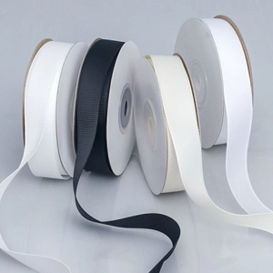 Assorted 1cm solid grosgrain ribbons in black and white on elegant marble background