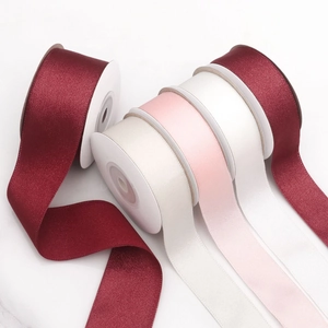 Macro detail of assorted colorful 4cm satin ribbons for DIY gift wrapping and crafts