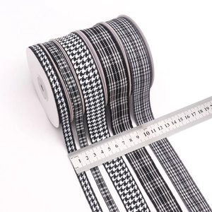 Classic black and white houndstooth and striped ribbons in various widths with measuring ruler