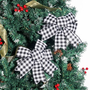 Pair of black and white checkered bows on a Christmas tree with festive decorations