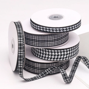 Rolls of black and white houndstooth and plaid ribbons for DIY hair accessories and crafts