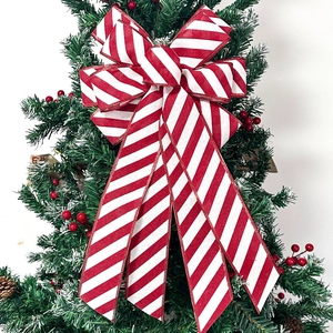 Classic red and white striped Christmas bow decoration used as a festive tree topper