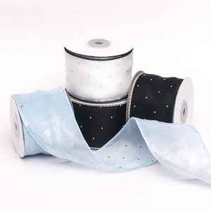 Close-up of 6cm sheer organza ribbon with sparkling rhinestones on white spools