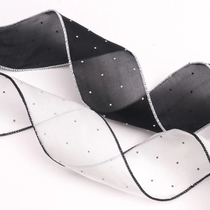 Close-up of 6cm black and white rhinestone tulle ribbons with contrast stitched edges