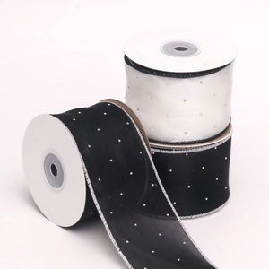 Close-up of black and white 6cm sheer organza ribbons with silver rhinestones on rolls